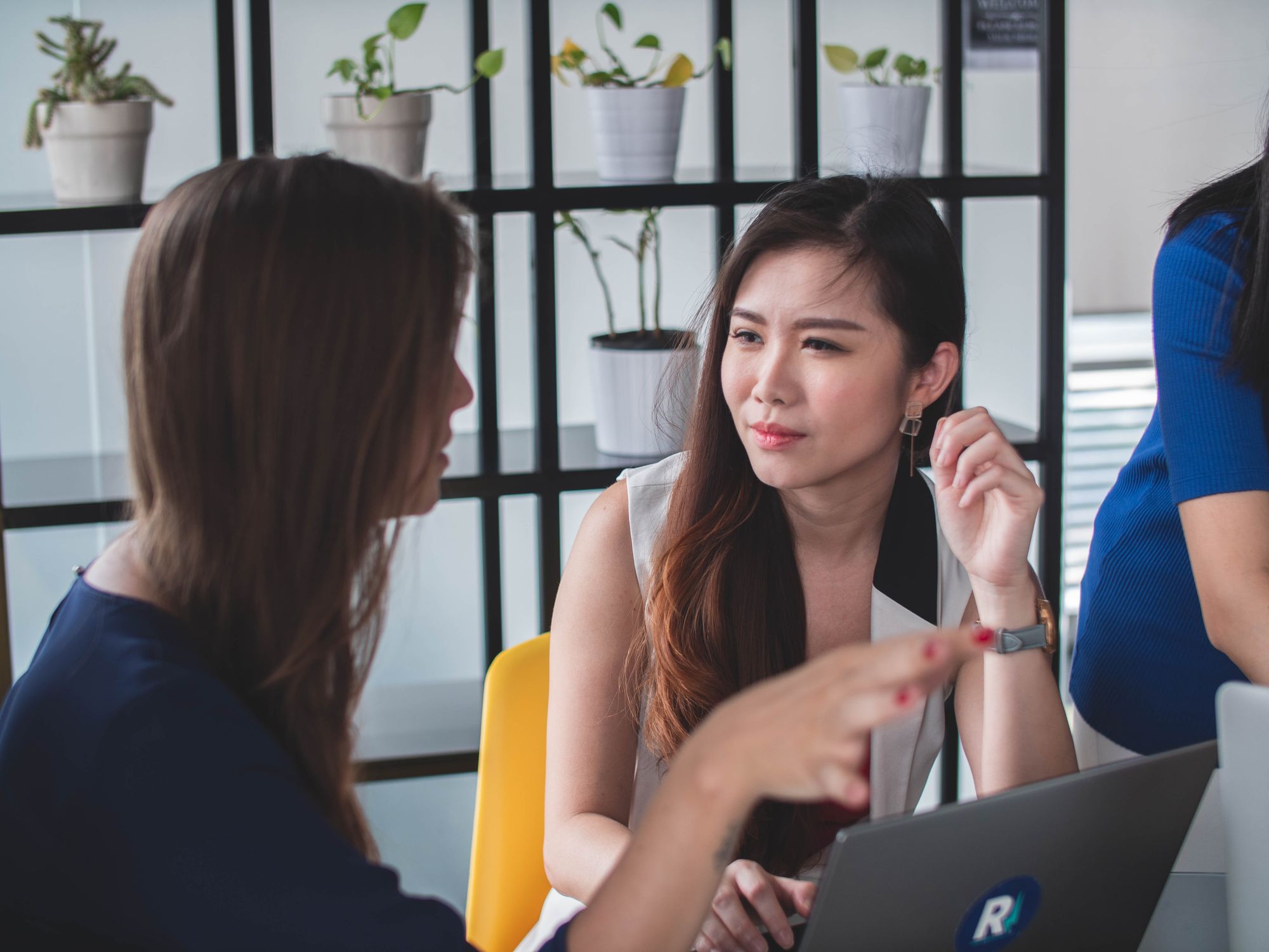 woman listening to another woman talking at work